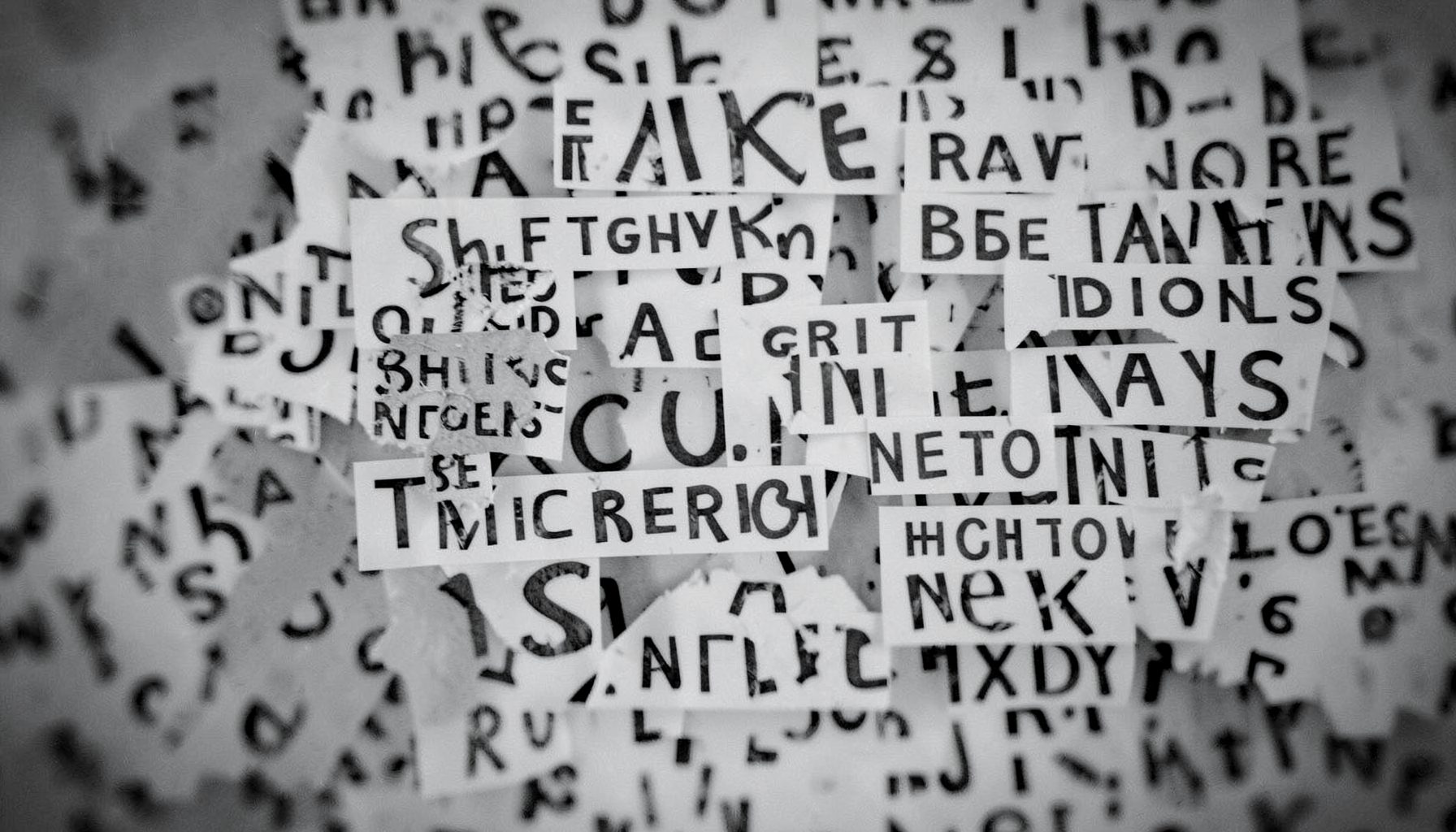 A grayscale abstract composition with fragmented text-like shapes, evoking confusion, fake news, and digital misinformation